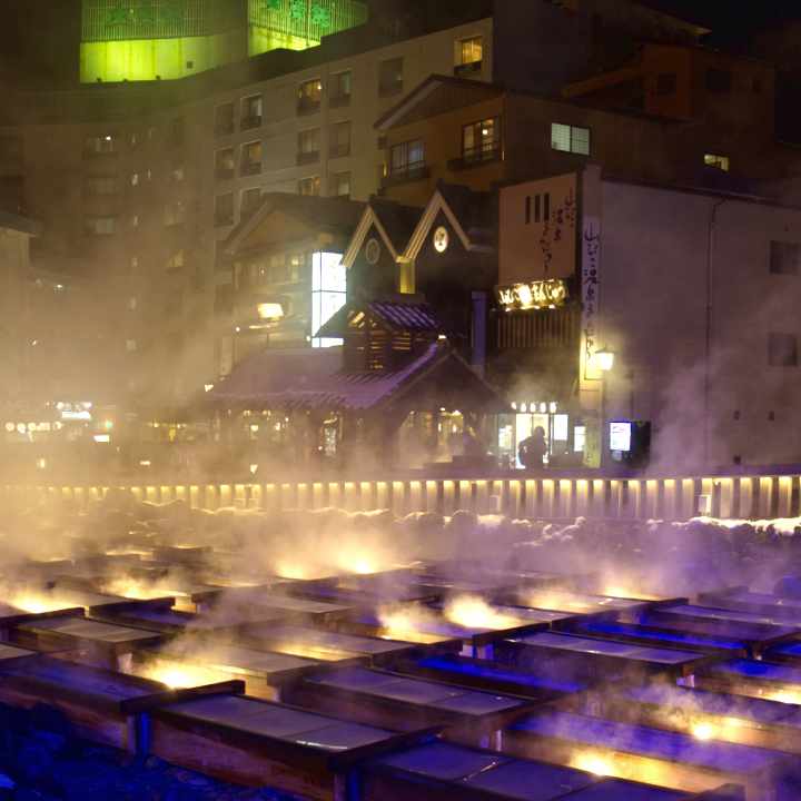 Kusatsu Onsen Yubatake lit up at night